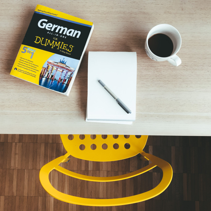 Table flat lay including a version of "German for Dummies".