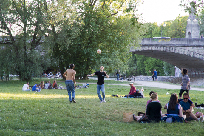 people having a picnic and others playing volleyball