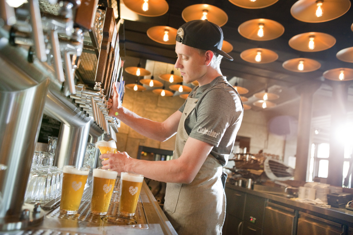 Waiter drafting a craft beer.