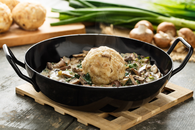 Bread dumpling served with a creamy mushroom sauce.