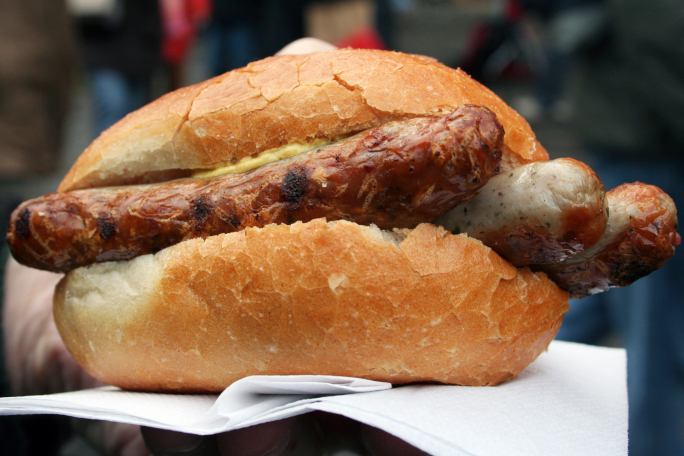 Three  Nuremberg sausages in a bread roll.