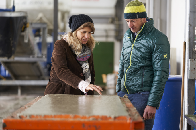 Andrea Kustermann and Michael Weiß examine concrete in a container