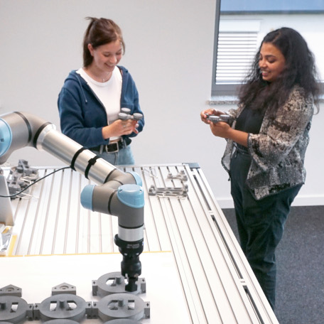 Pooja Prajod with a student assistant from the MindBot team experimenting with a cobot.