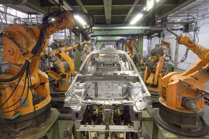Industrial robots manufacturing a car