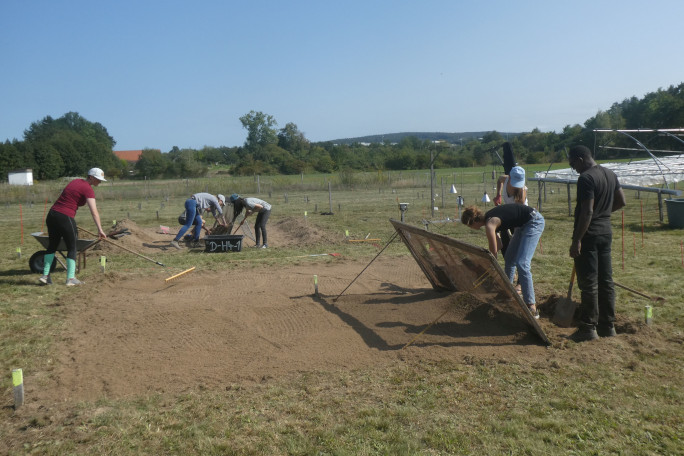 Students working in the field with soil