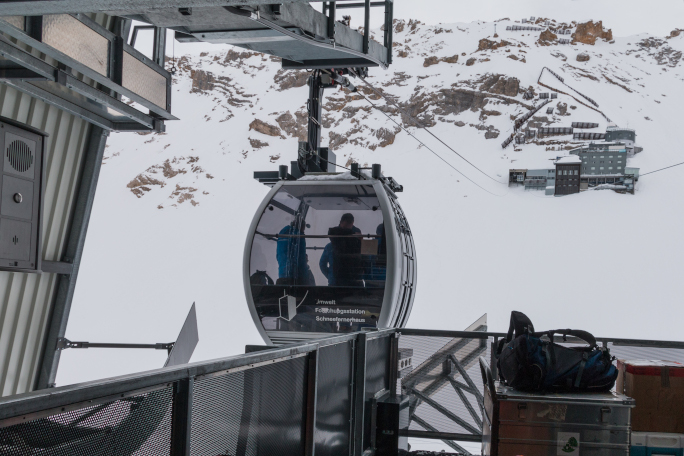 Gondola entering the station in the snowy moutains.