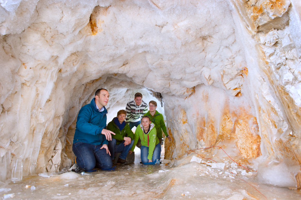 Guide shows visitors around in a tunnel dug.