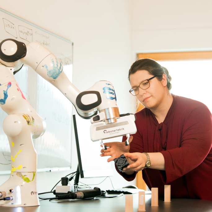 Researcher working with a robot