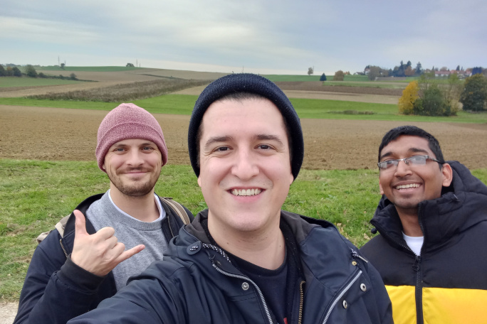 Selfie of the three start-up founders with wide field in the background