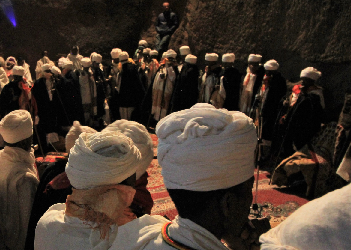 Men with wearing turbans stand in a circle.