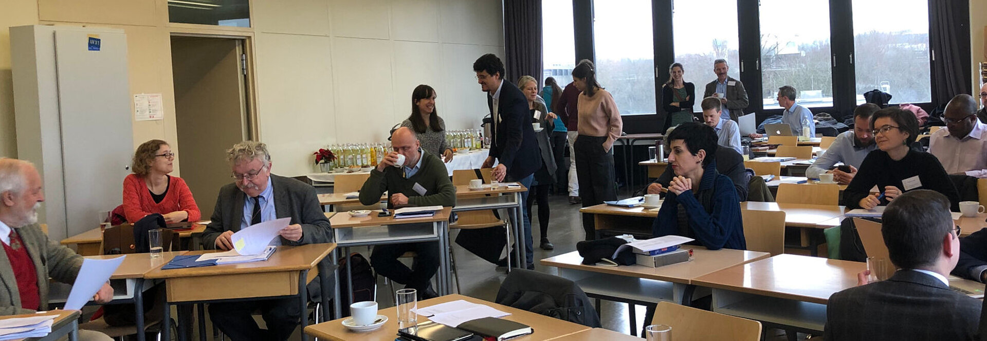 People sitting at tables during a conference coffee break