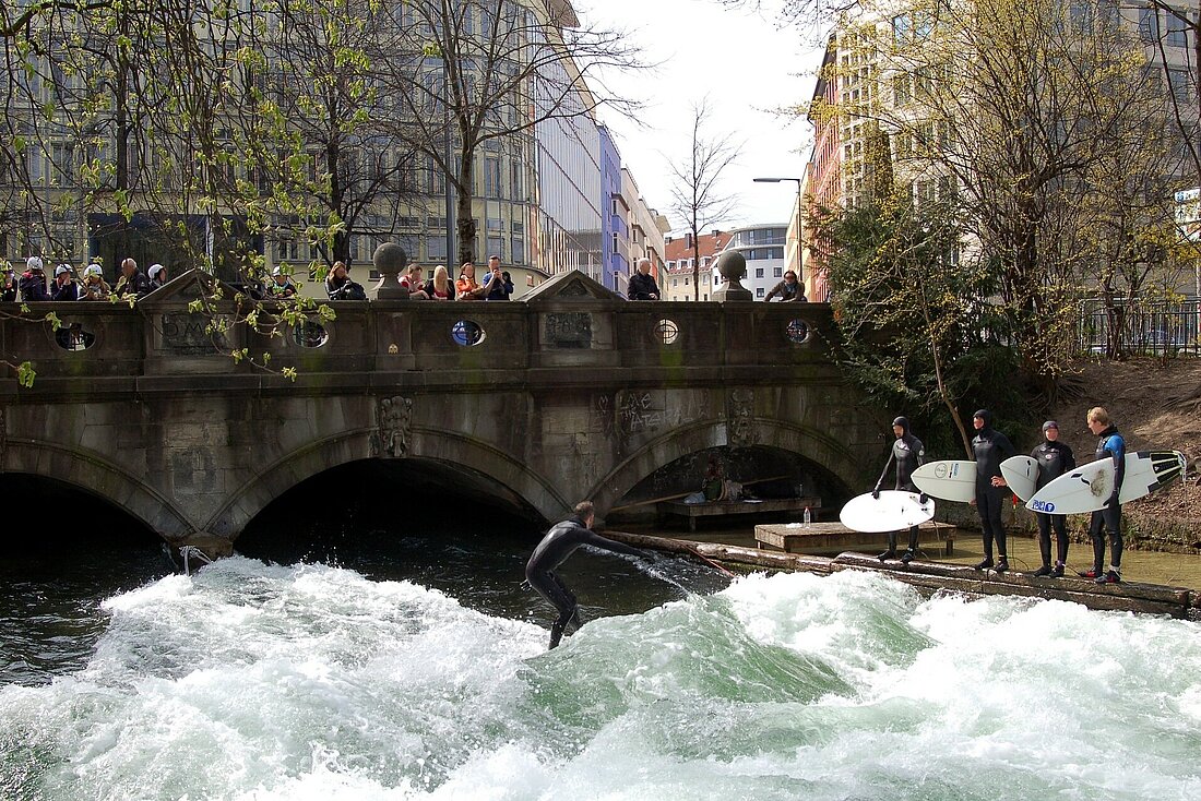 people surfing on a standing wave