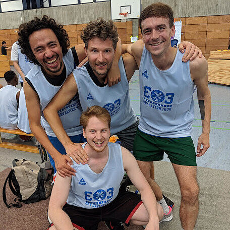 The author with basketball three other basketball team members posting for the photo.