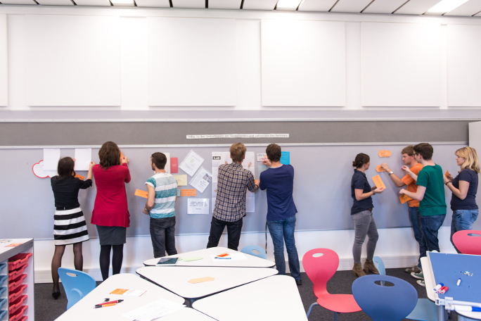 PhD candidates working in groups during a transferable skills course.