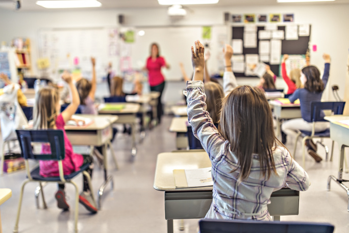 Classroom full of pupils participating in a teacher-centered class.