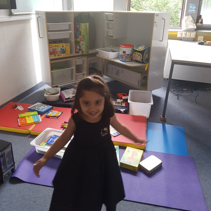 Child in the office in front of a game box