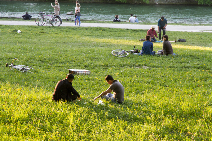 People sitting in the grass and enjoying the sun 