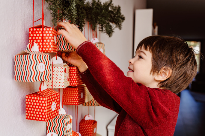 Little boy is opening presents