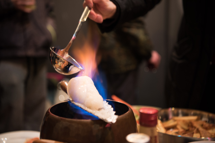 Hot drink poured into a cup over a cube of sugar