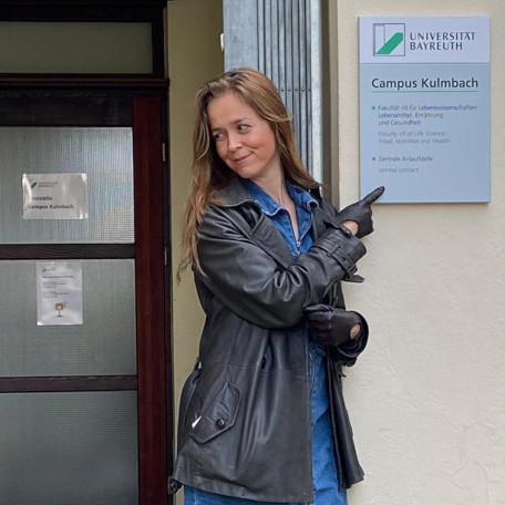 researcher pointing on a sign of the new Faculty