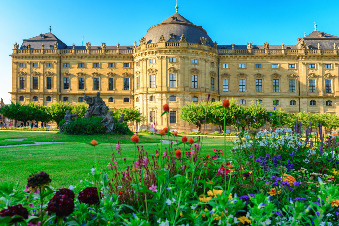 Castle in the background with green blooming garden in the foreground