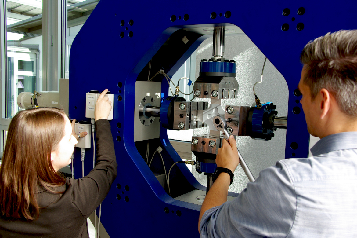 Two people working on a machine.