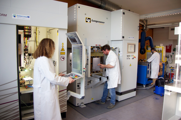 Three researchers working in the laboratory