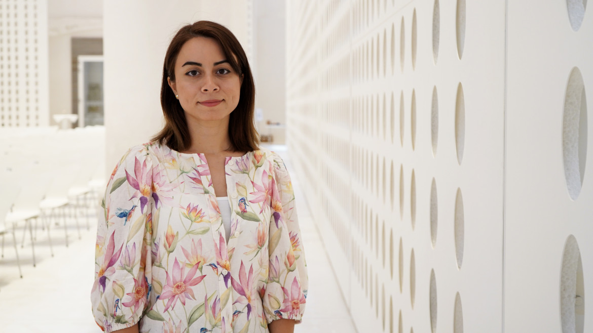 The young researcher standing in the aula of the university.