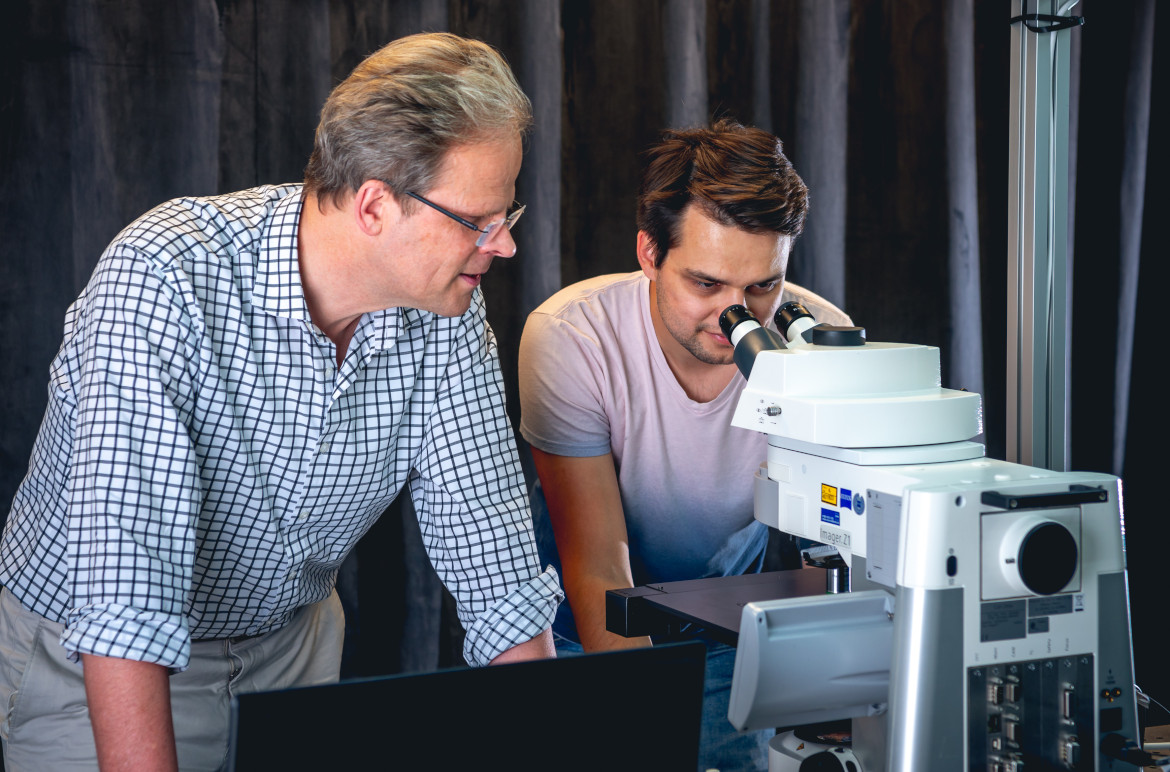 Two researcher in quantum mechanics observing something
