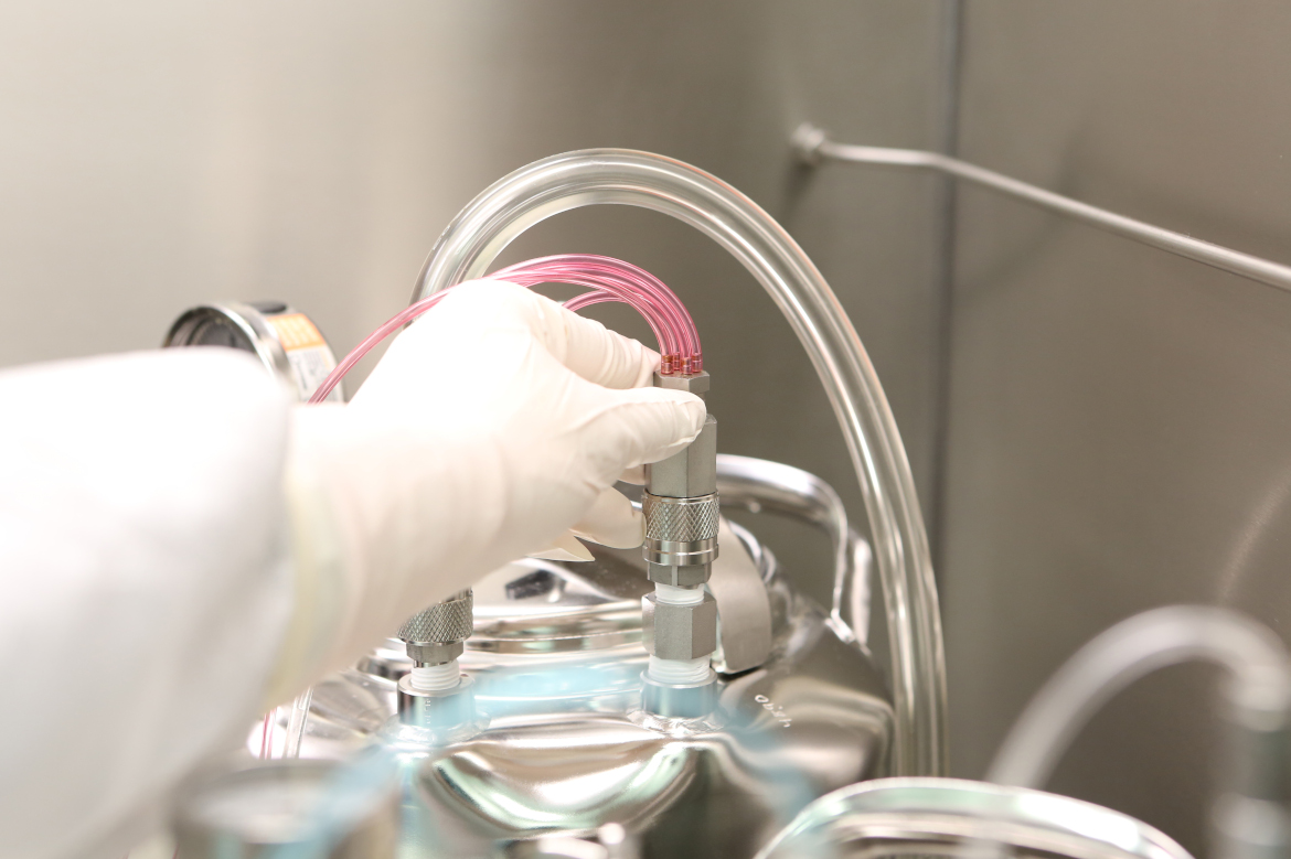 Hands in gloves working on a Machine in the Laboratory