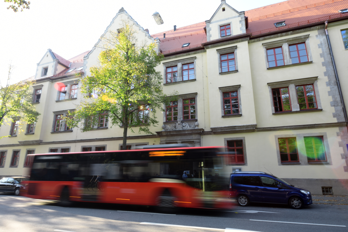 The IOS building seen from outside with a bus driving in front of it. The center collaborates closely with the university in area studies.
