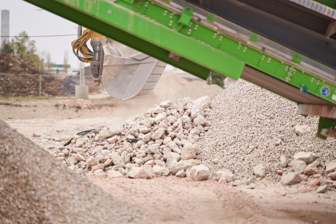 Crushing and screening plant with a excavator in the background 